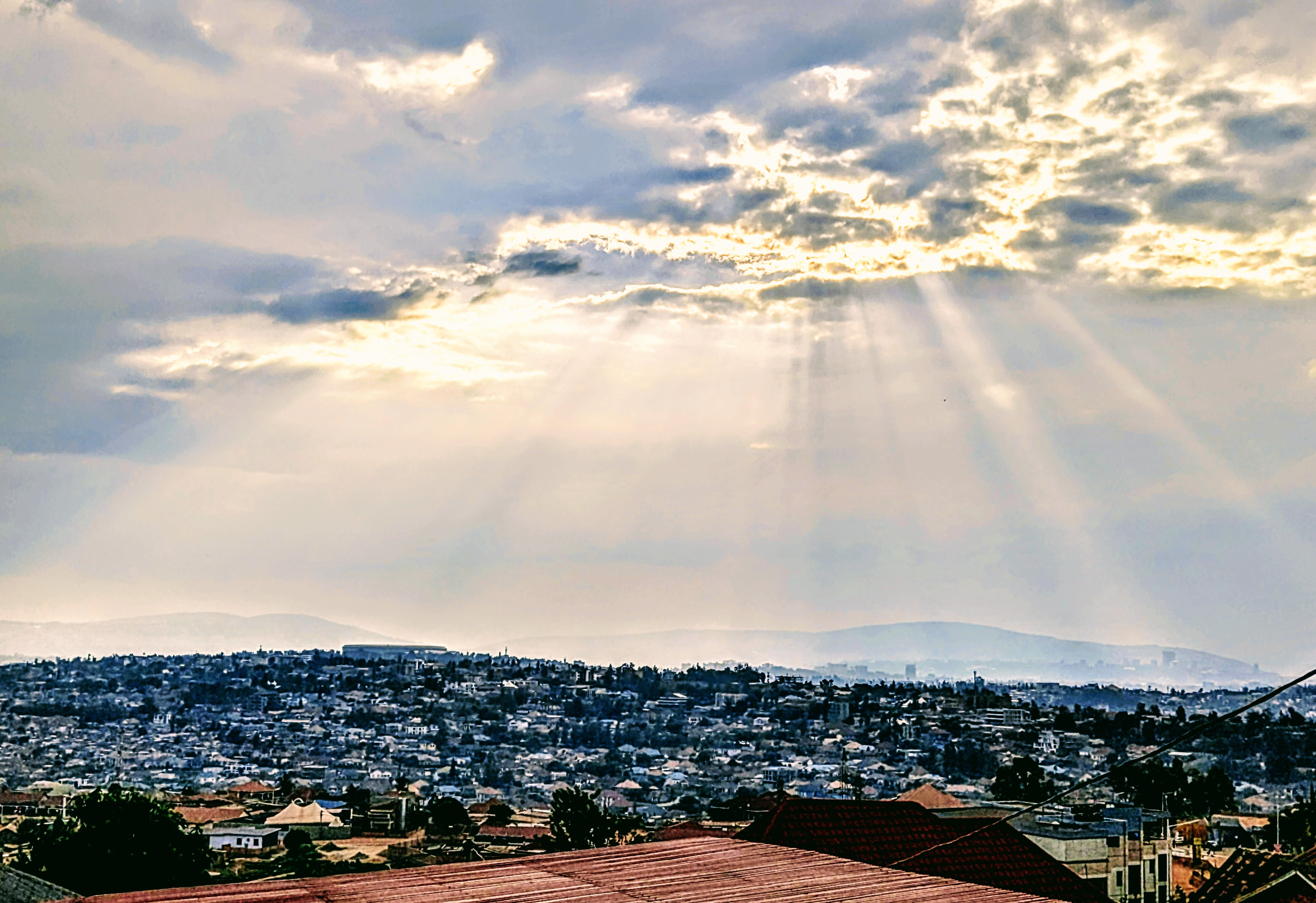 A shot of Kigali With The Sunlight Breaking Through The Clouds