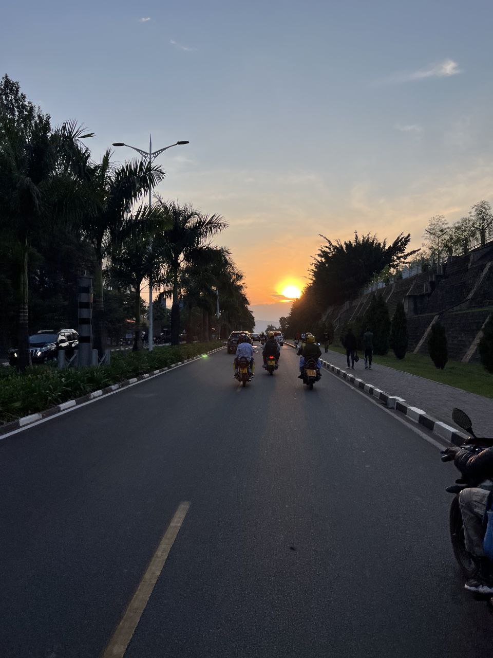Kigali road at sunset with bikes
