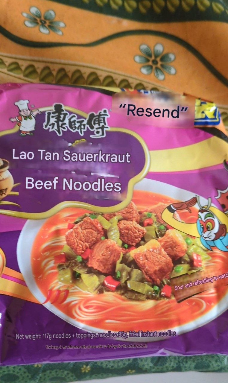 Translated Chinese noodles packet on display showing Lao Tan Sauerkraut Beef Noodles (117g+toppings)