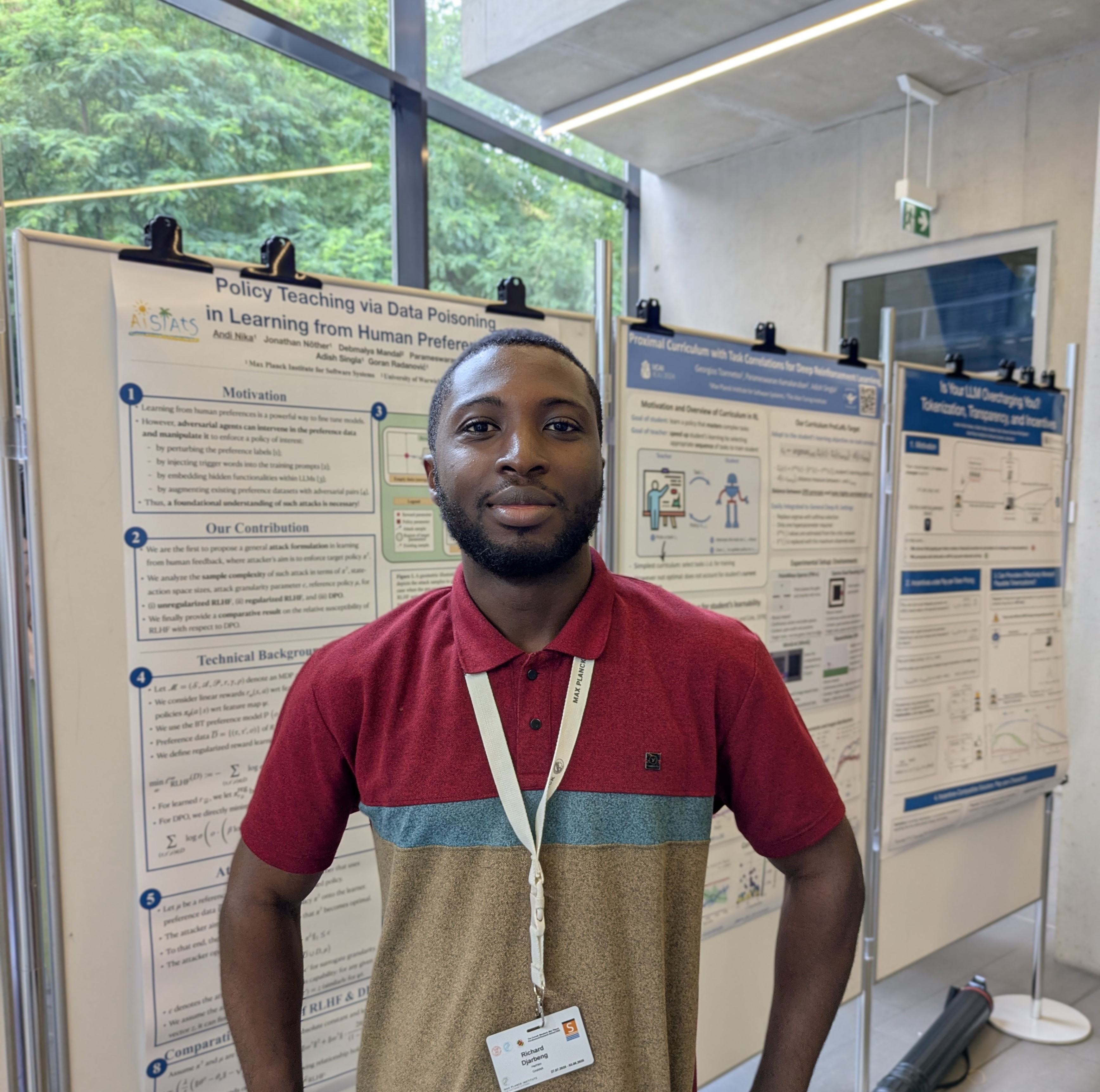 RIchard Djarbeng in front of research posters at MPI-SWI cmmrs